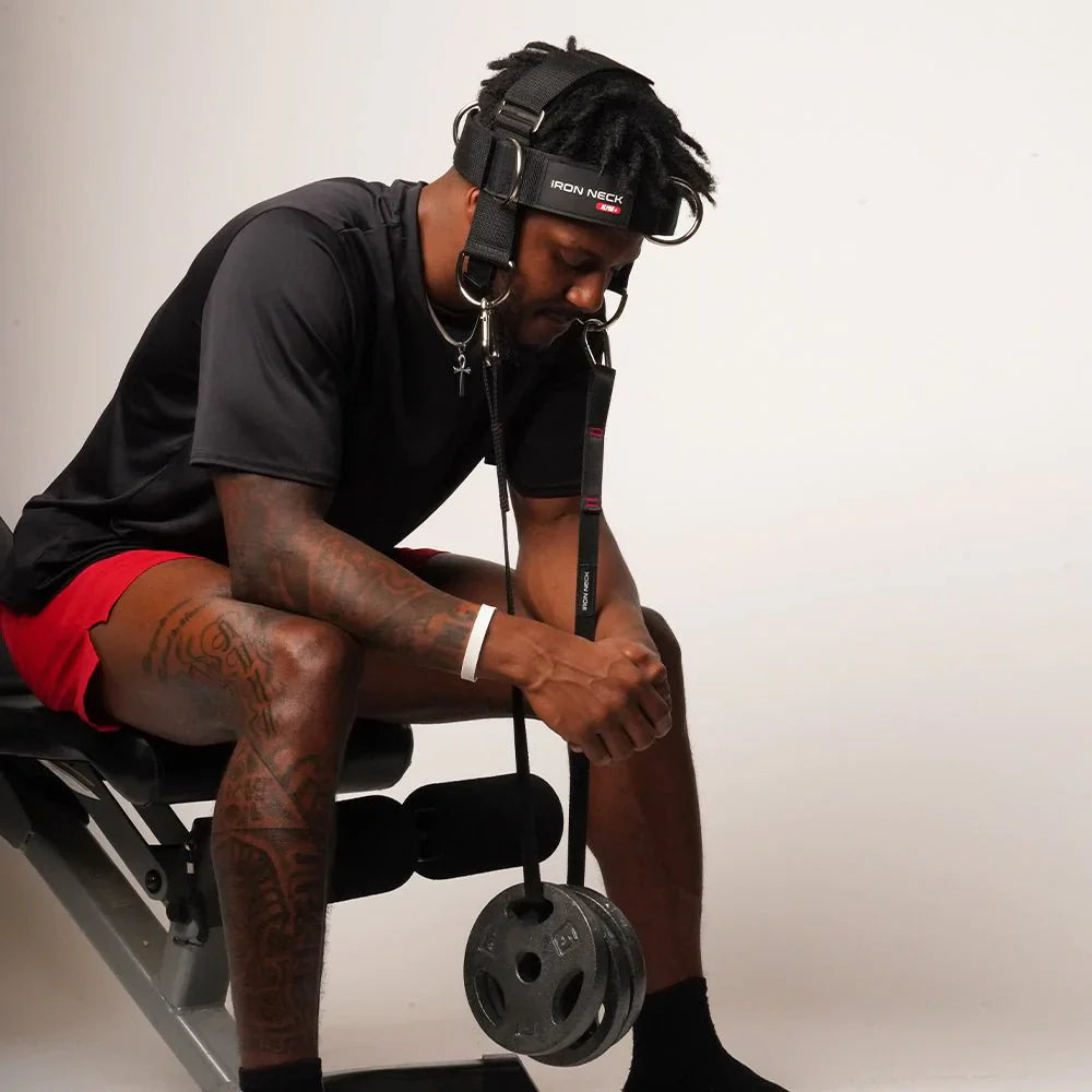 Performing a neck flextion with eights on the Iron Neck Alpha Plus Harness