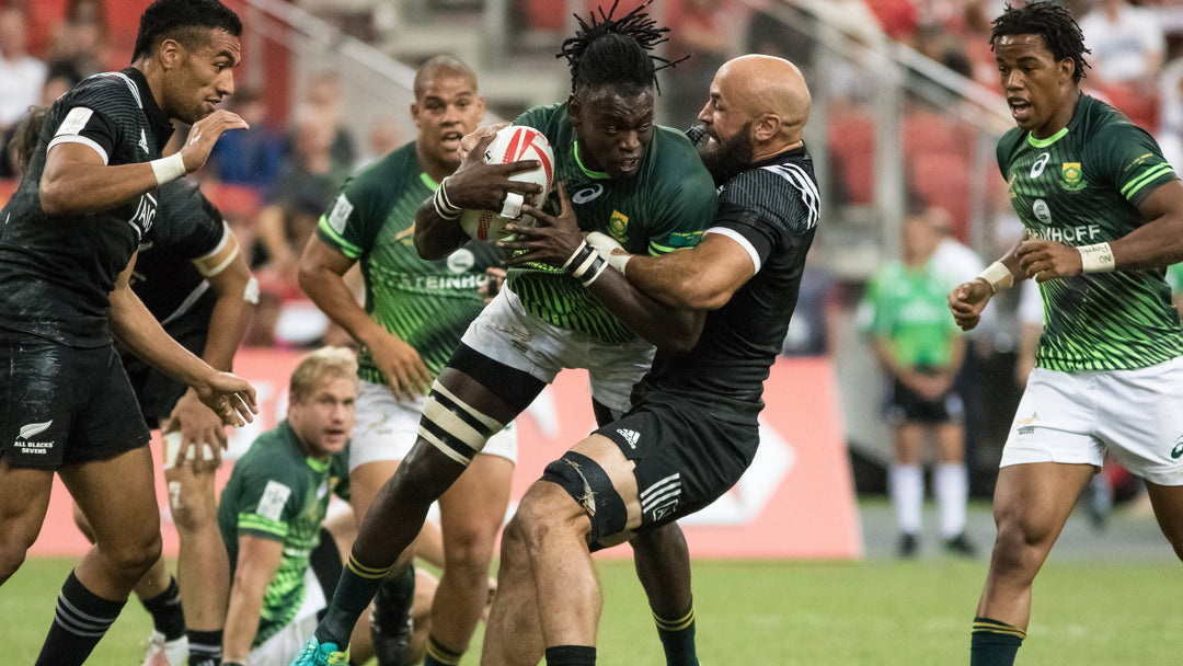 Rugby player getting tackled.